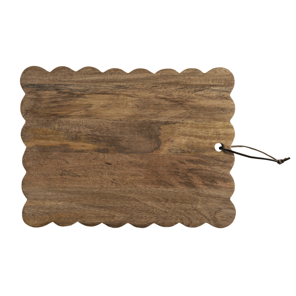 Scalloped dark wood cutting board with natural grain and leather hanging loop on white background.