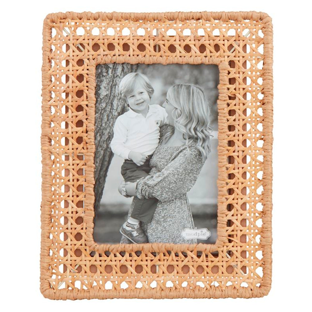 Mud Pie natural woven cane photo frame featuring a classic rattan web pattern and a black and white family portrait.