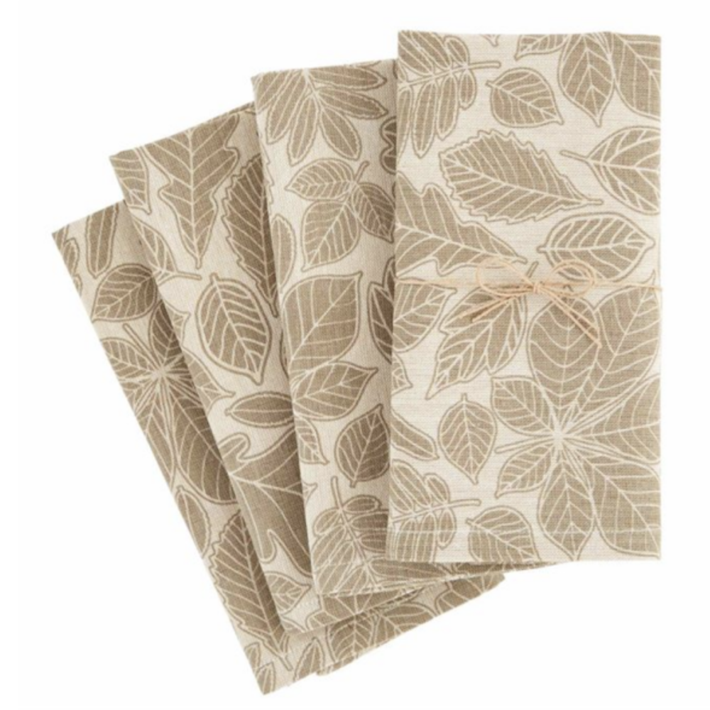 Set of four folded beige cloth napkins featuring a leaf print pattern tied with a twine bow.