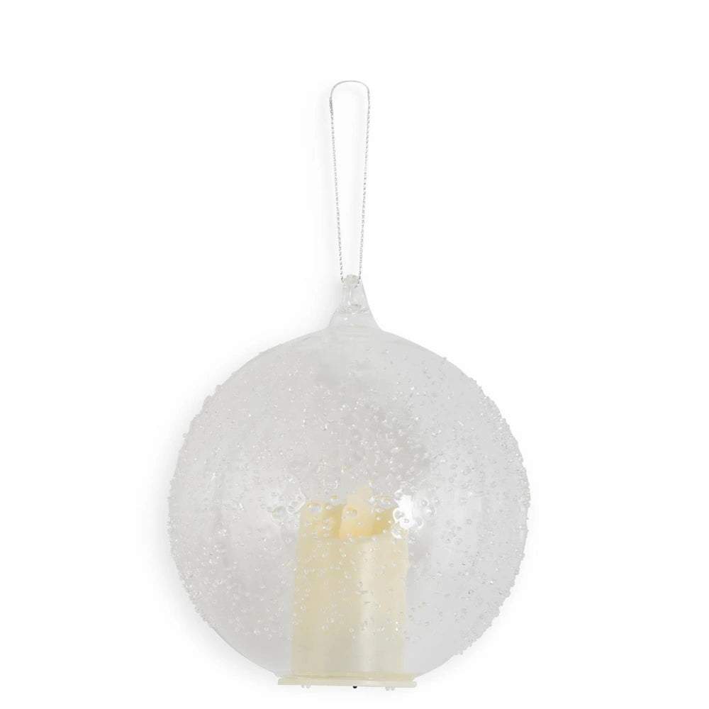 A hanging textured clear glass round ornament featuring an internal LED candle and a silver string.