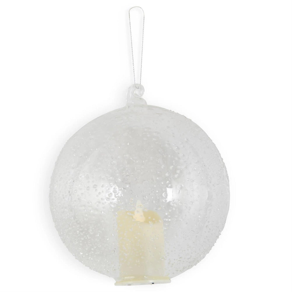 A hanging textured clear glass round ornament featuring an internal lit LED candle and a silver string.