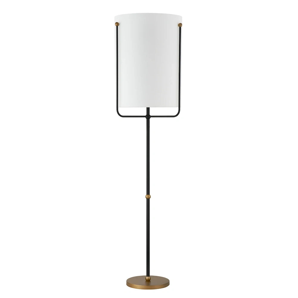 Modern black and brass floor lamp with tall white cylindrical shade and slim round base.