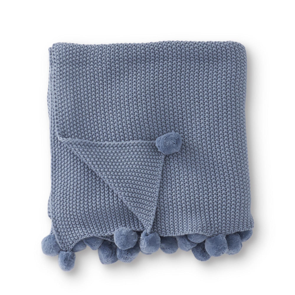 Light blue moss stitch knit throw blanket with pompom trim.