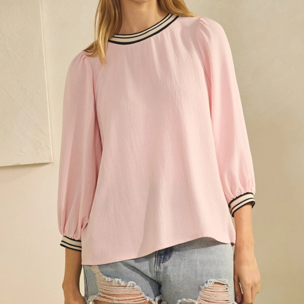 Light blush airflow top with puff sleeves, striped collar and cuffs, paired with distressed denim jeans.