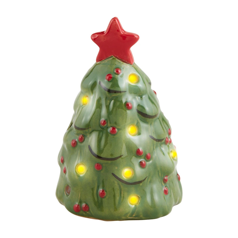 Small ceramic green Christmas tree figurine with a red star topper and glowing warm lights.