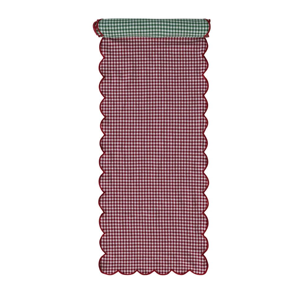 Reversible table runner with red and white gingham on one side, green gingham on top, and scalloped trim.