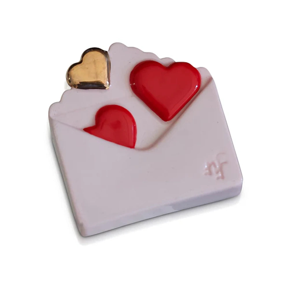 White envelope-shaped charm with two red hearts and one gold heart emerging from the top against a white background.