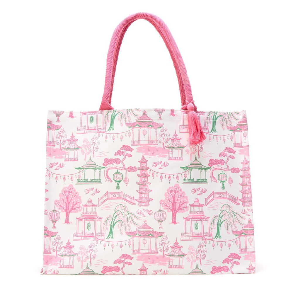 Pink and green block print tote bag with pagoda pattern and pink rope handles.