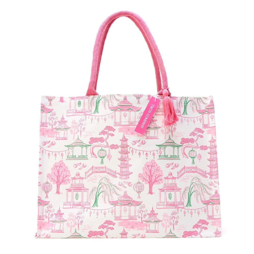 Pink and green block print tote bag with a branded tag and pink rope handles.