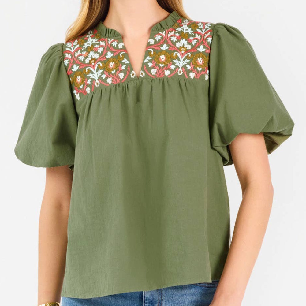 Olive green blouse with floral embroidery around the V-neckline and short puff sleeves.