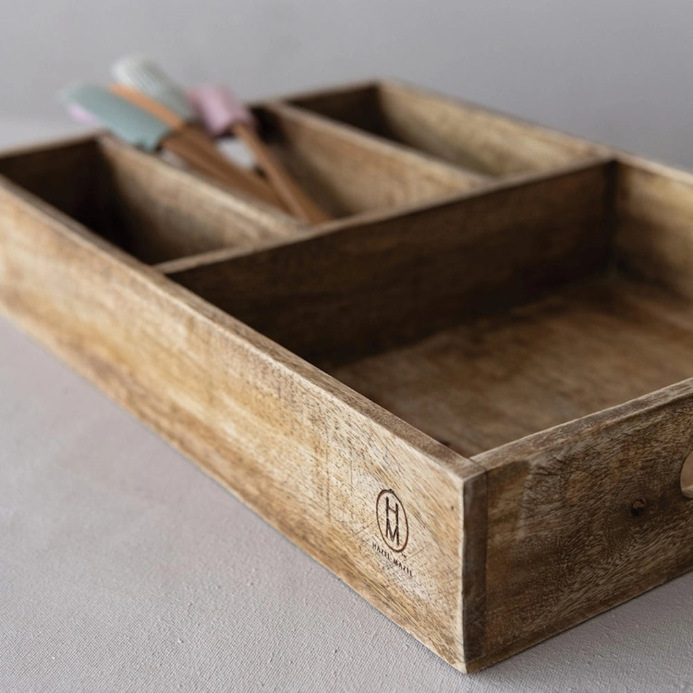 Four-section mango wood organizer tray with built-in handles holding kitchen spatulas.