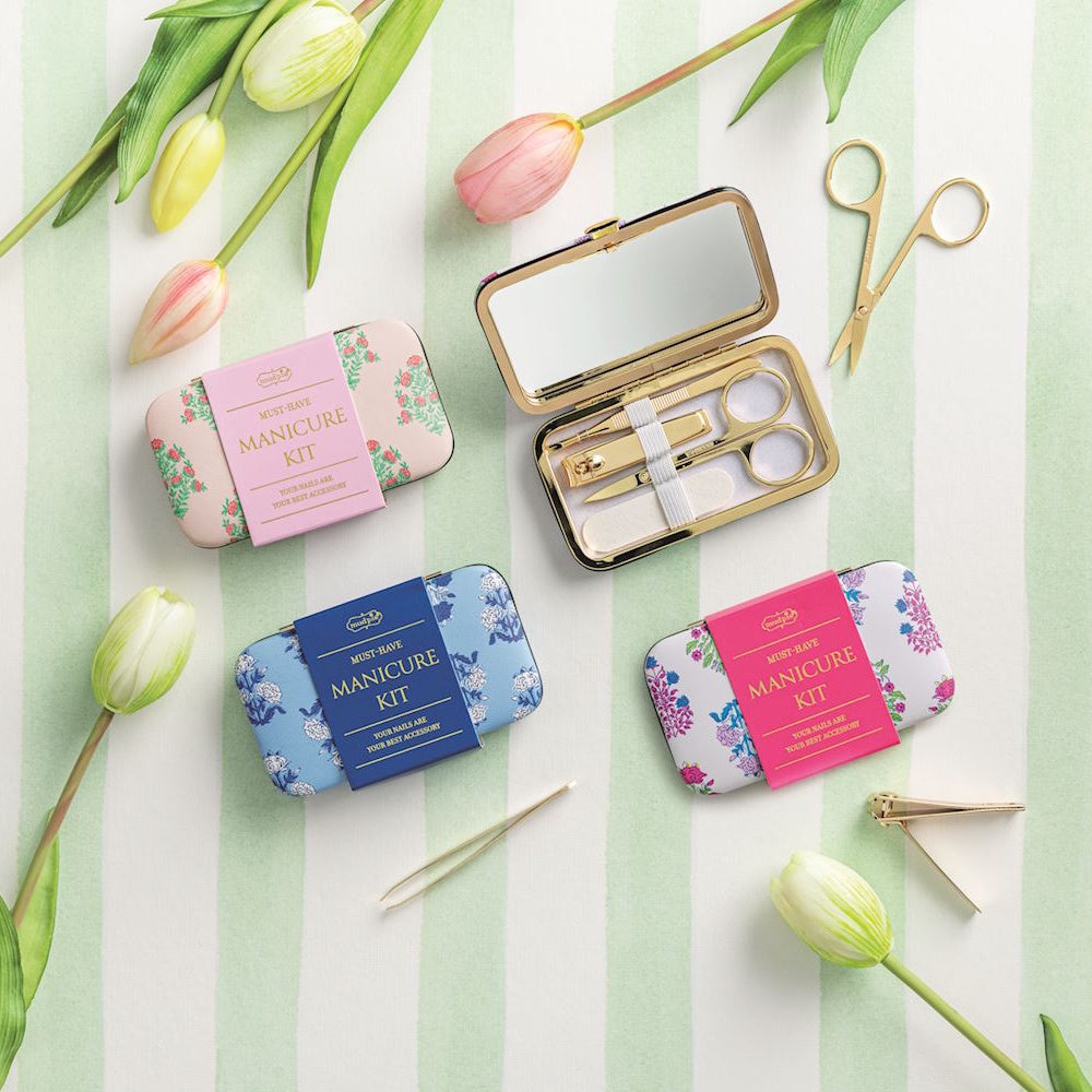 Floral pattern manicure kits in pink, blue, and white with gold tools and tulips on a striped background.