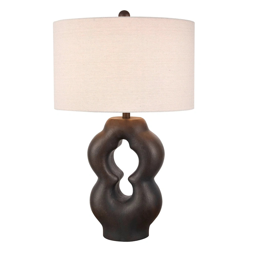 Modern sculptural bronze table lamp with a dark brown wavy base and a cream-colored linen drum shade for home decor.
