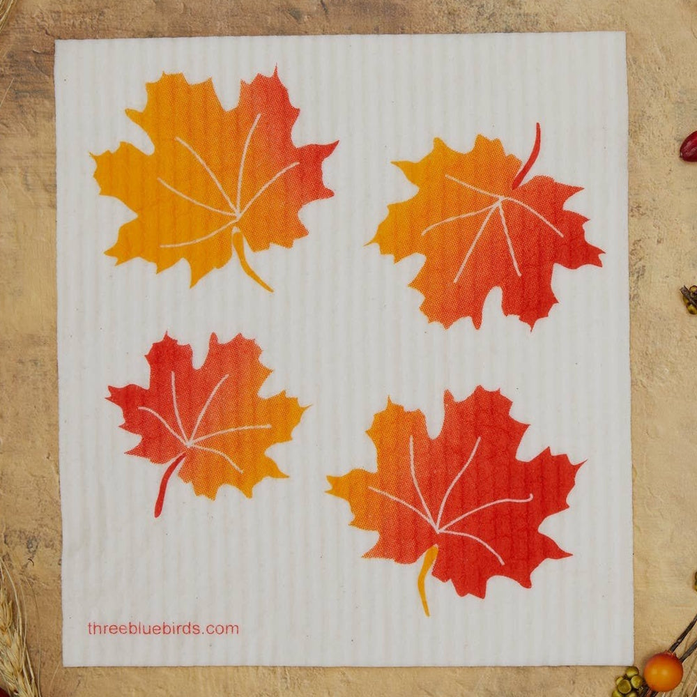 Square Swedish dishcloth featuring four colorful orange and red autumn maple leaves.