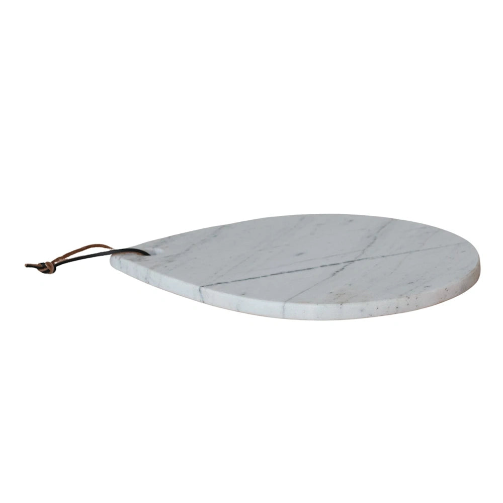 White marble teardrop cheese board with natural grey veining and a brown leather hanging tie on a white background.
