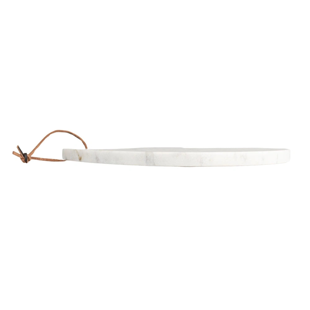 A simple white marble round serving board with a thin tan leather strap, shown in profile on a white background.