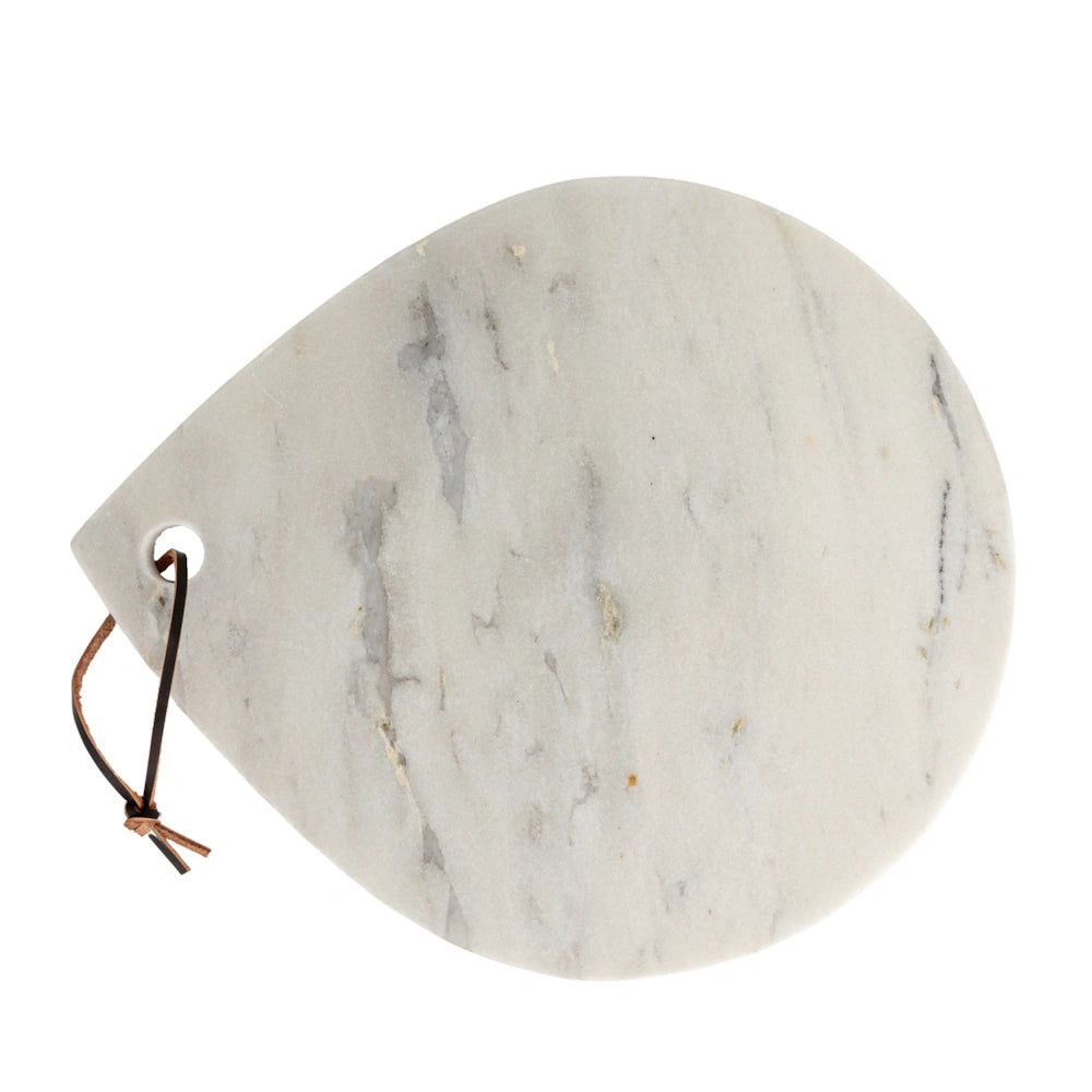 Teardrop-shaped white marble cheese board with a brown leather hanging loop on a white background.