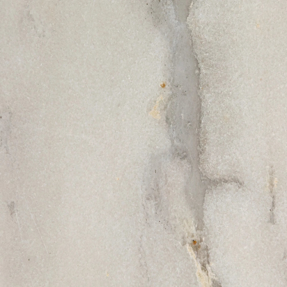 Close-up of white marble texture with natural grey and beige veining for a stone cheese board or serving tray.