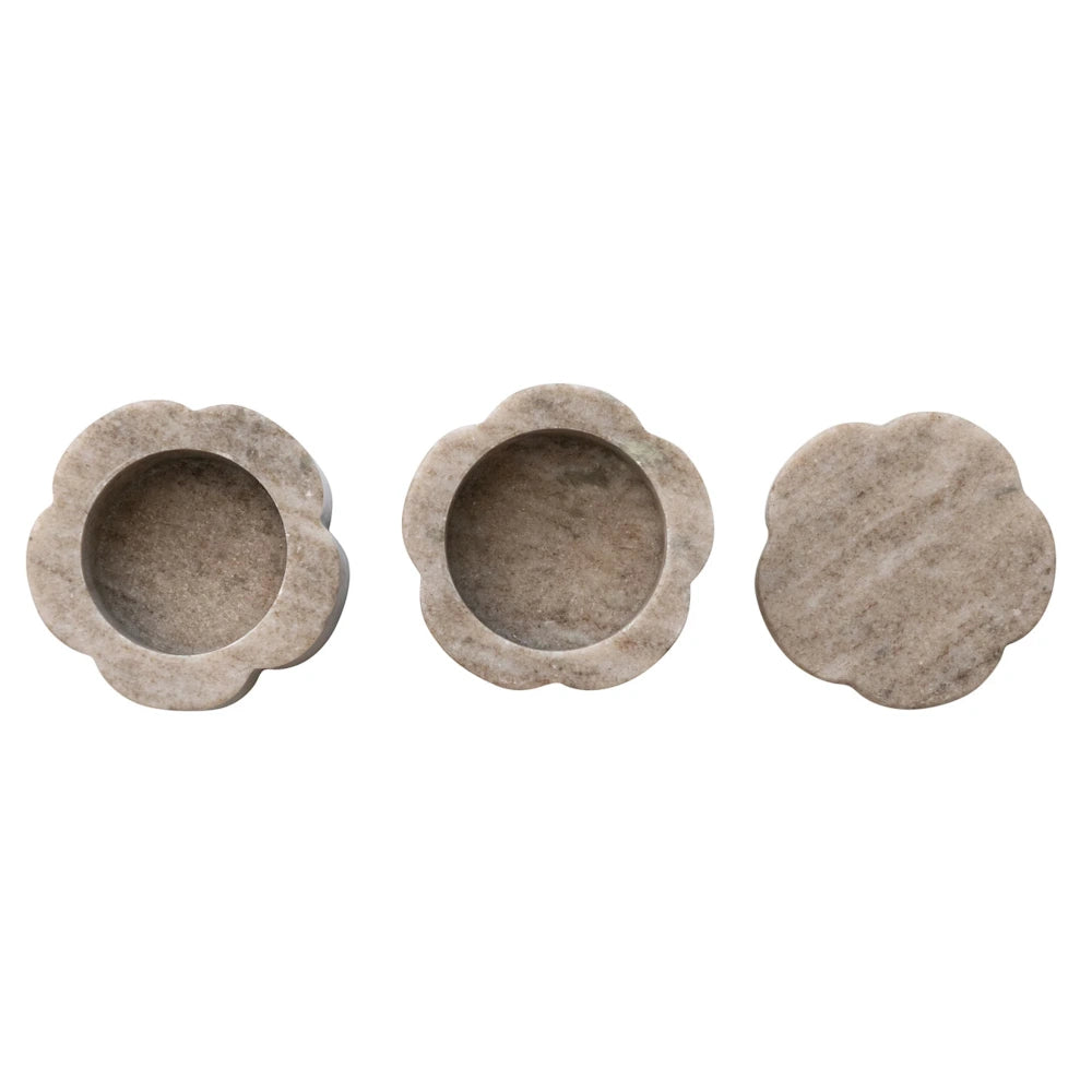Hand-carved scalloped marble trinket dishes and tea light holders in neutral stone for home decor.