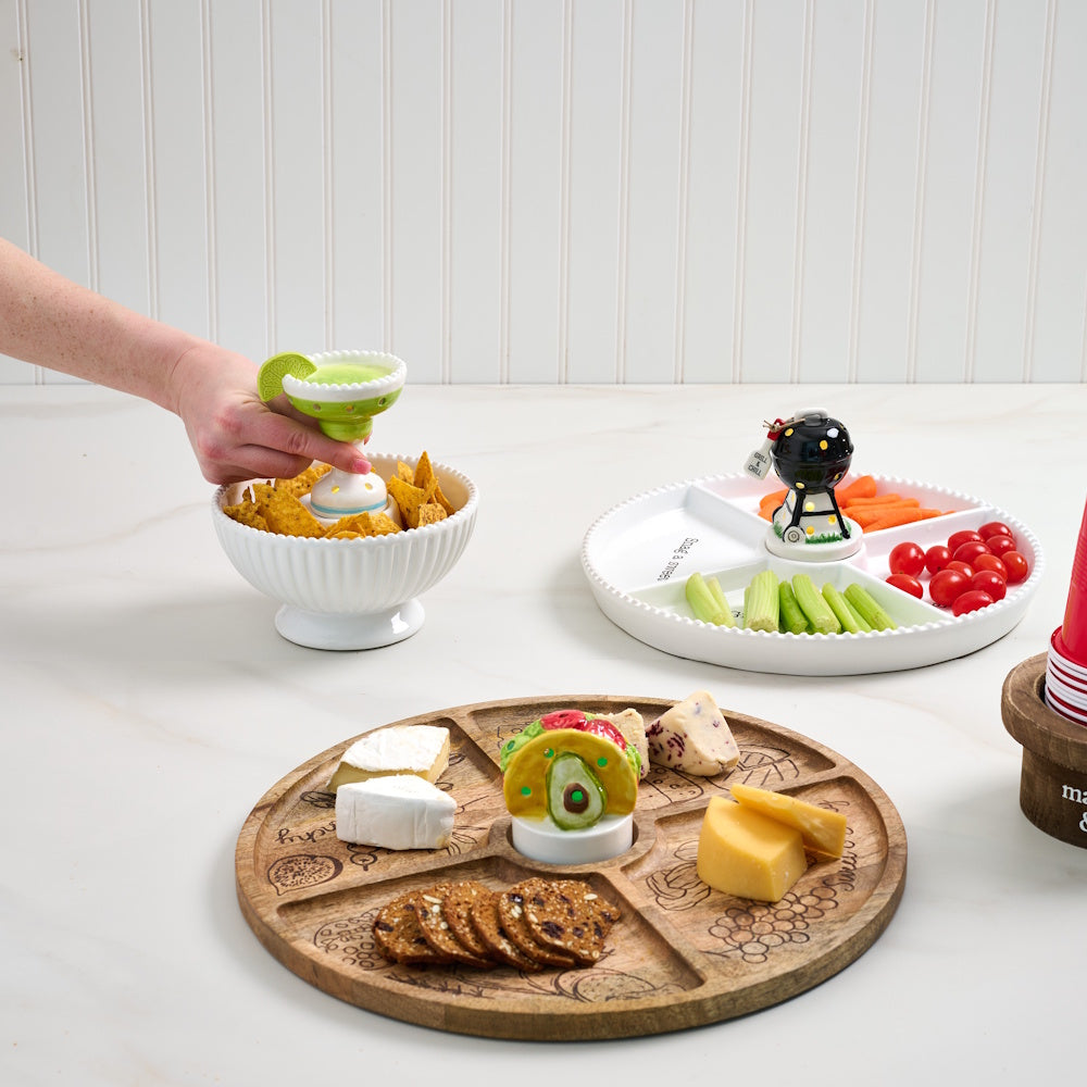Assorted serving platters with chips, cheese, and vegetables featuring margarita, taco, and grill themed light-up sitters.