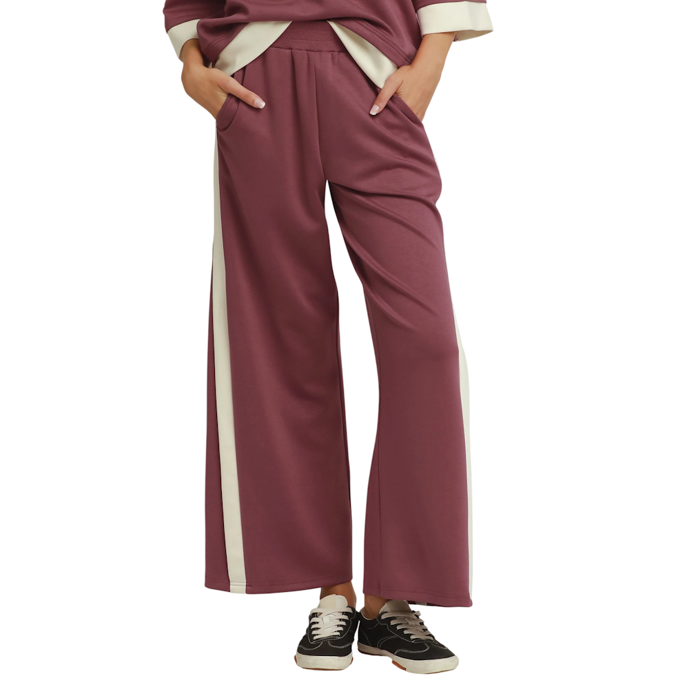 Mauve wide-leg knit pants featuring a cream side stripe, elastic waistband, side pockets, and relaxed fit.