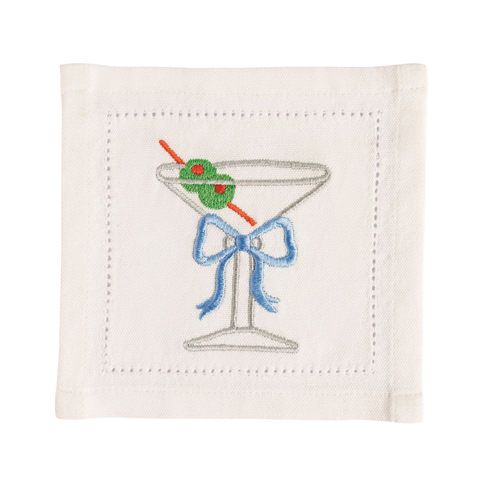 White linen cocktail napkin featuring an embroidered martini glass with a blue bow and olive garnish.