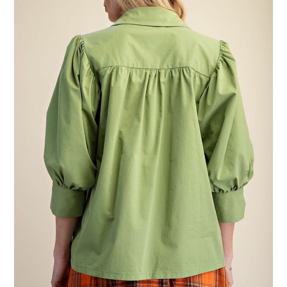 Back view of a matcha green cotton poplin blouse with puffed sleeves and a gathered back yoke.