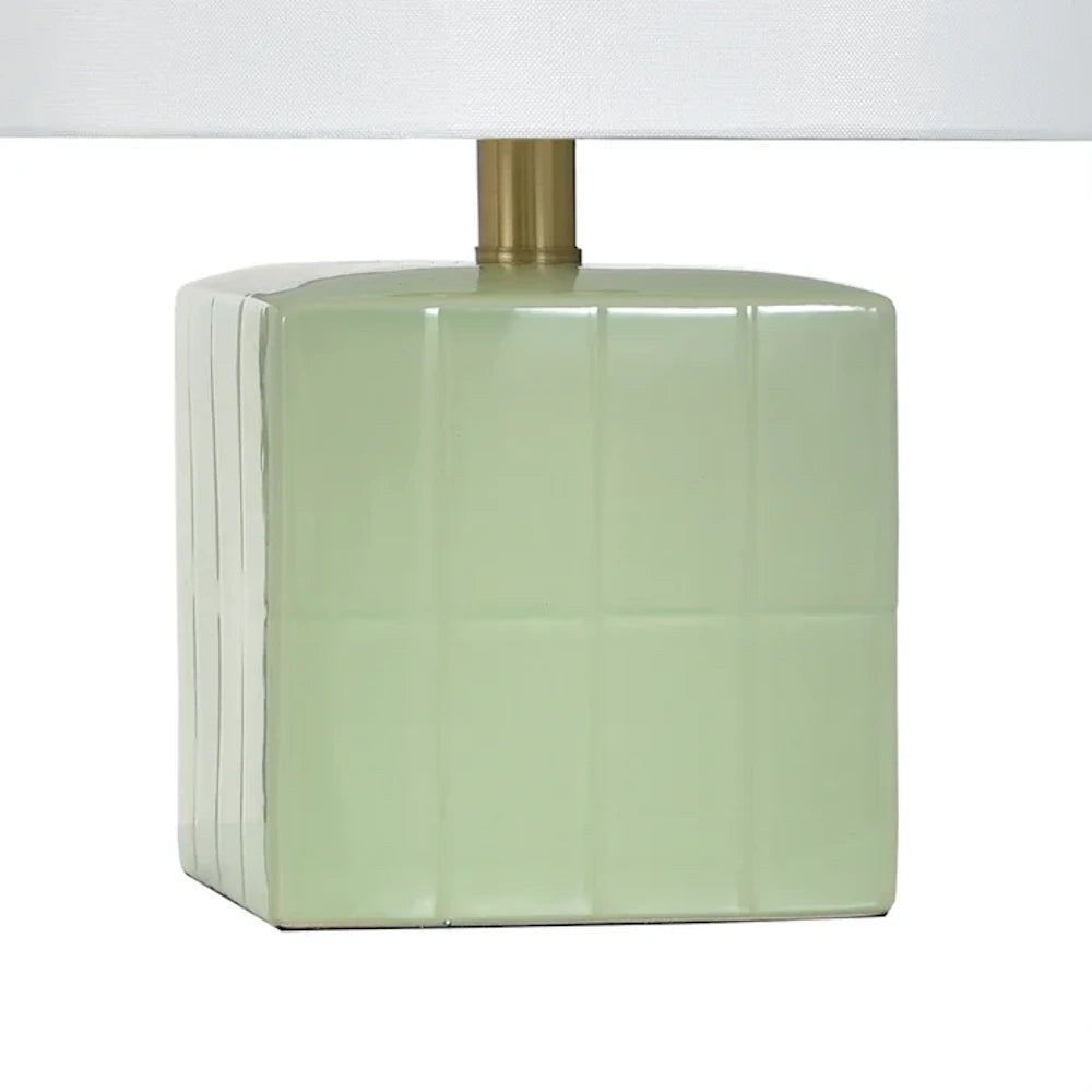 A mint green square ceramic lamp base with a grid texture, gold neck, and white lampshade on a white background.