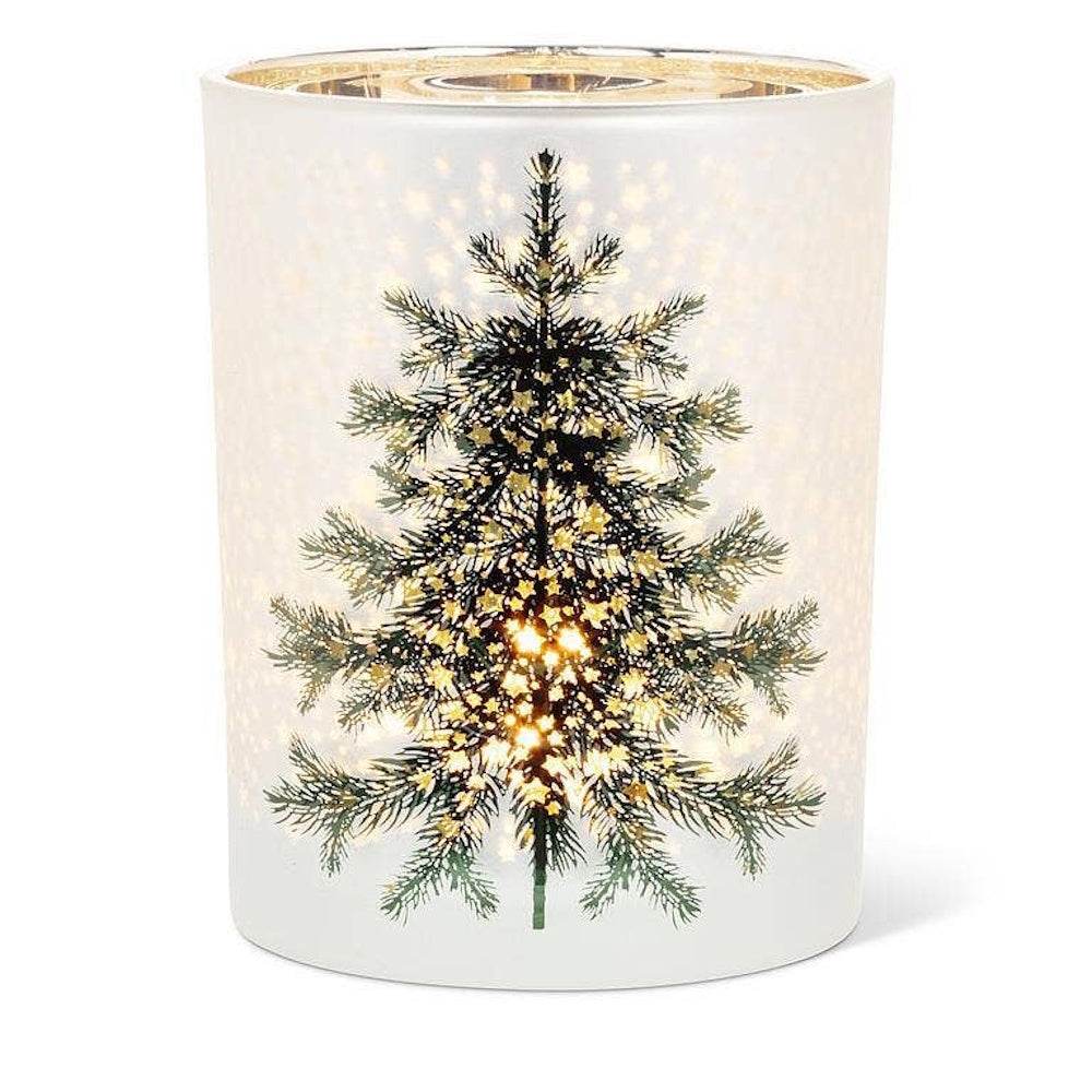 Frosted glass votive candle holder with an illuminated pine tree design and star pattern.