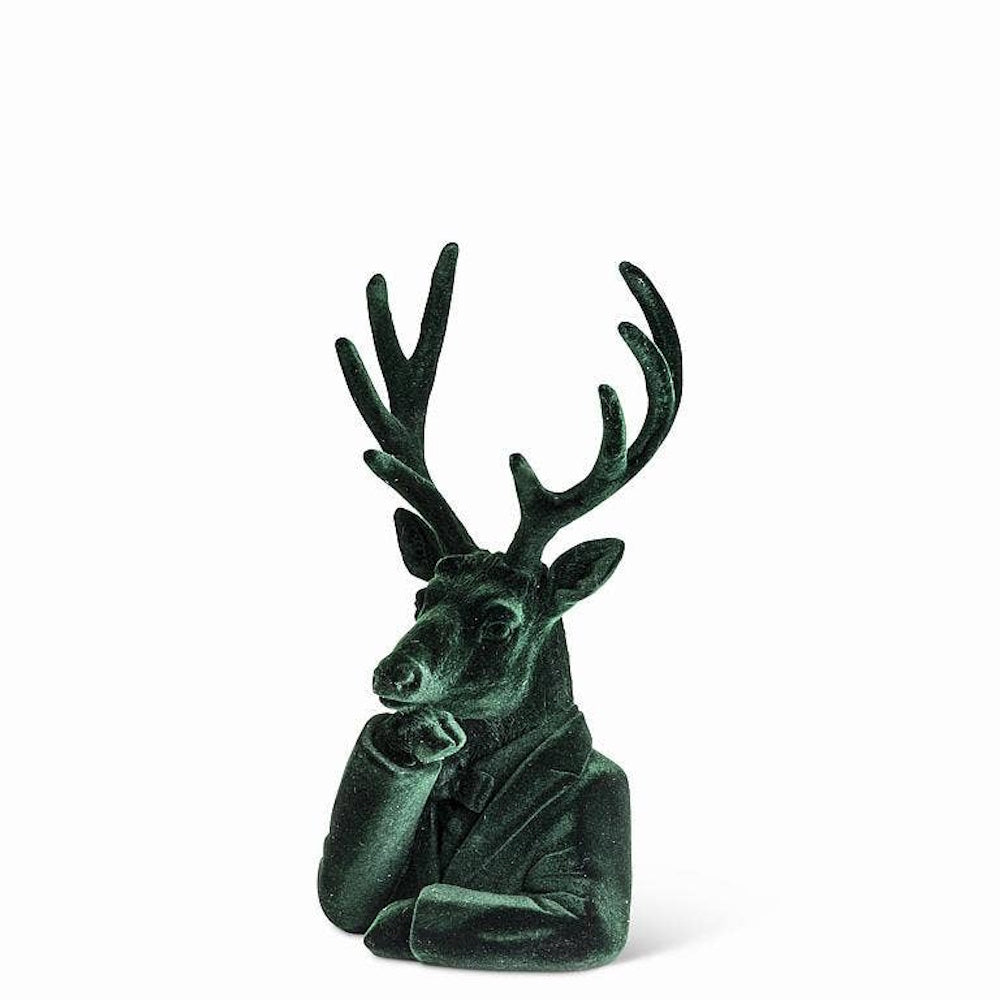Dark green velvet stag bust figurine in a suit jacket with hand on its chin.