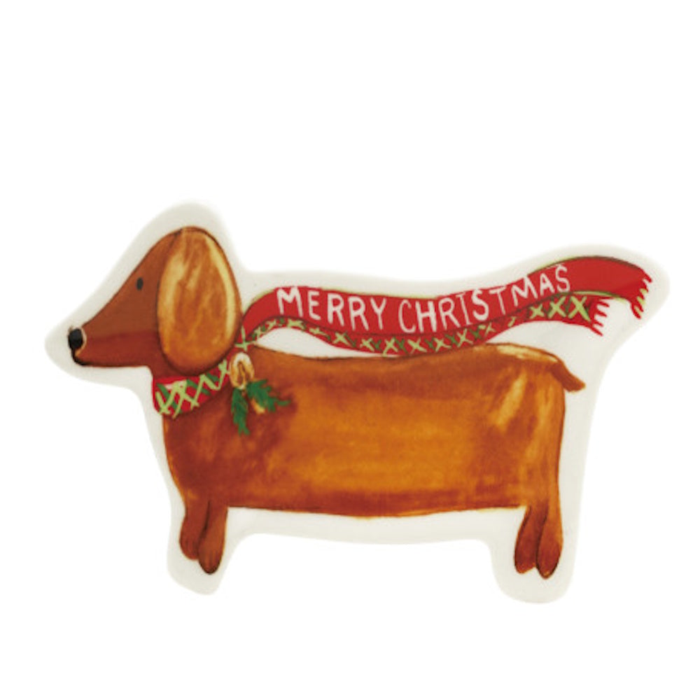 A stoneware dachshund dish wearing a red scarf that says "Merry Christmas".