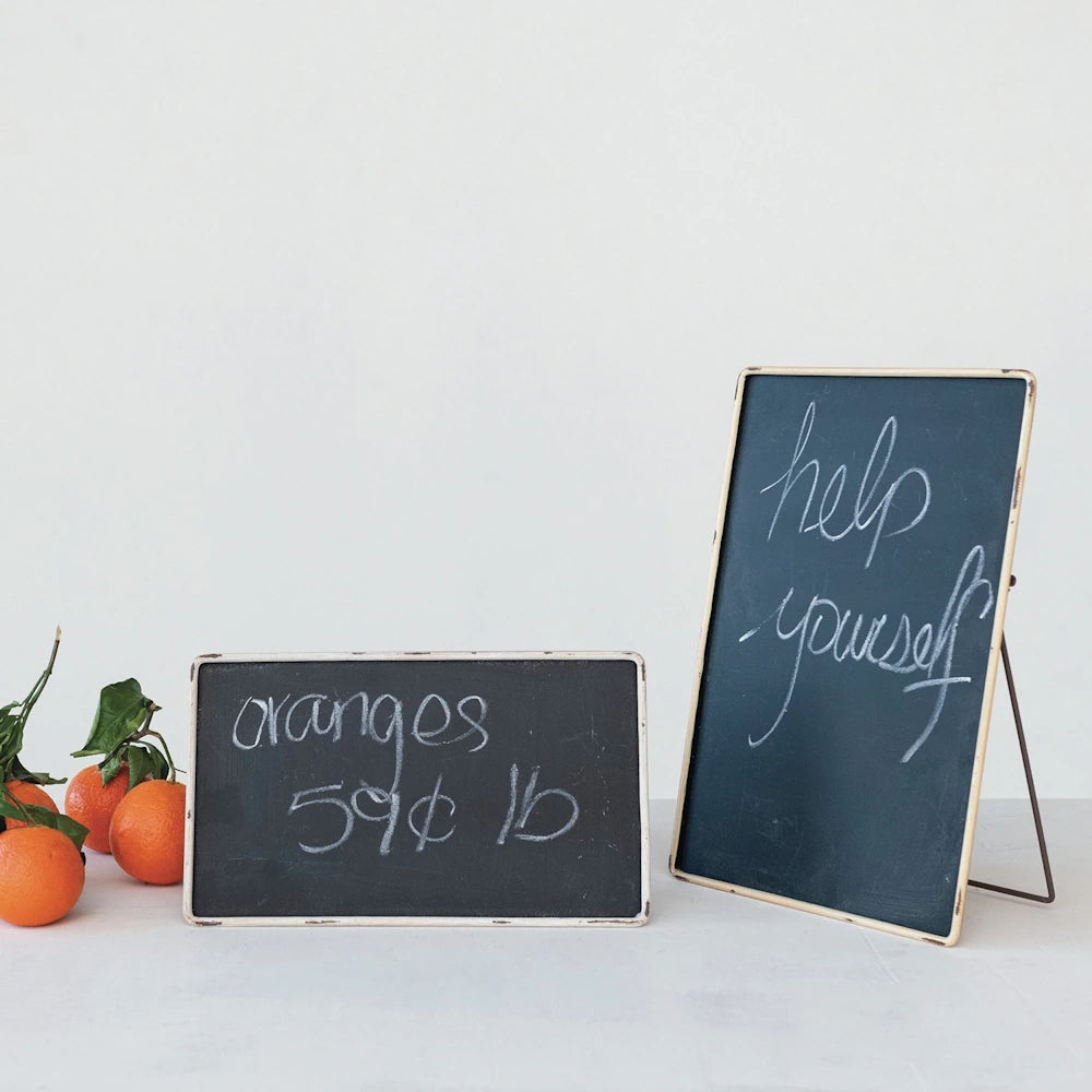Mini chalkboards with handwritten price and message, displayed with fresh oranges against a white background.