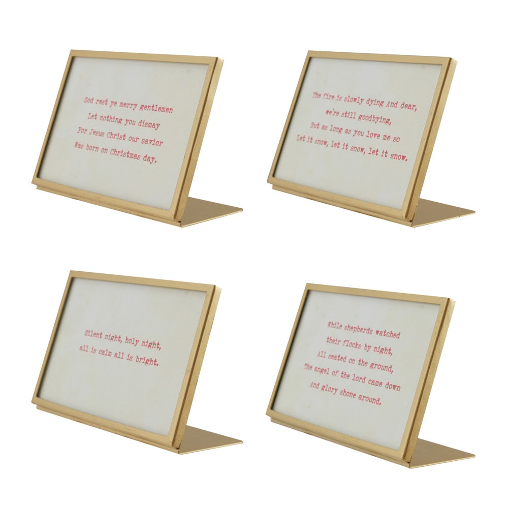 Four gold metal frame desk displays featuring printed Christmas carol lyrics and song quotes.