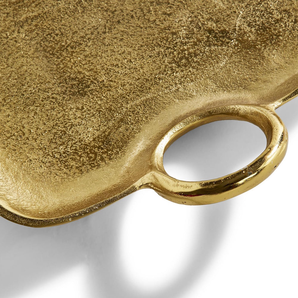 Close-up view of a textured gold metal decorative tray featuring an integrated rounded handle.