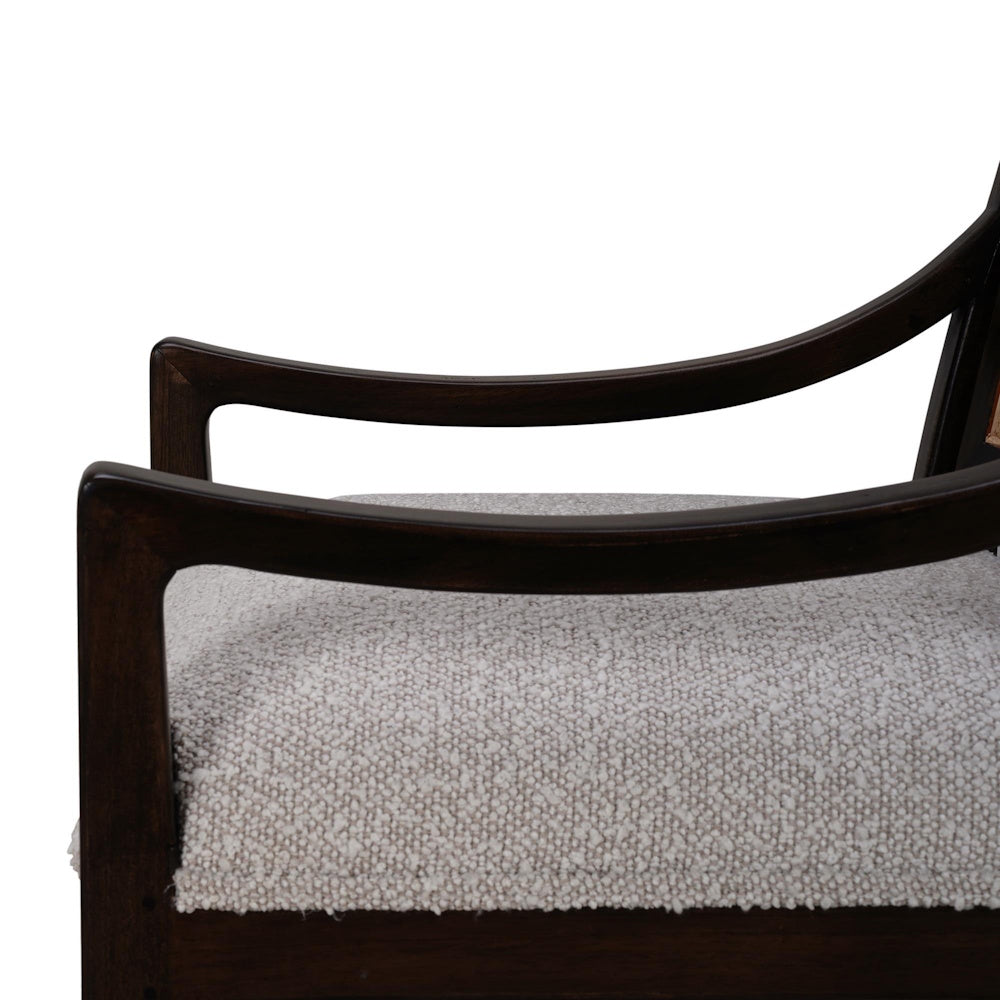 Close-up of Milano dining chair with a dark wood armrest and textured beige upholstered seat.