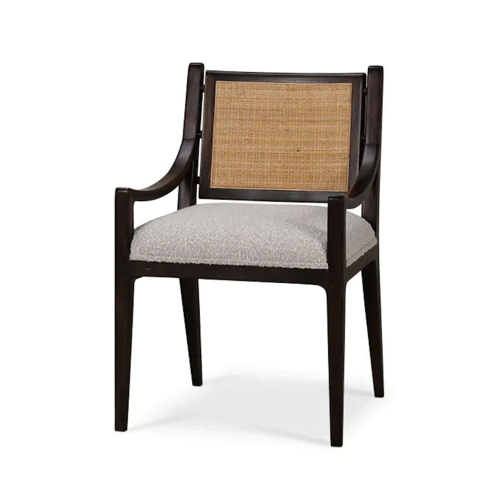 Dark wood dining armchair with woven rattan backrest and textured gray cushioned seat.