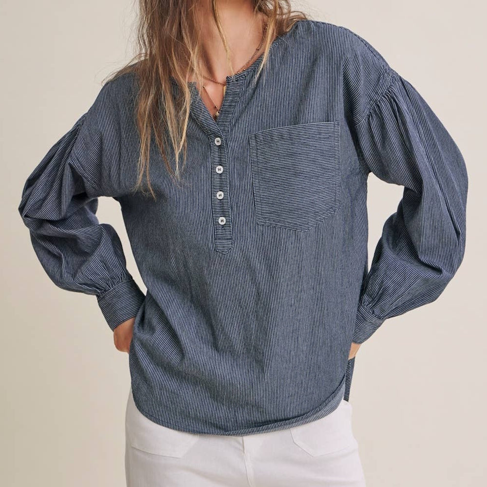 Blue and white pinstripe henley shirt with button front, chest pocket, and relaxed puff sleeves.