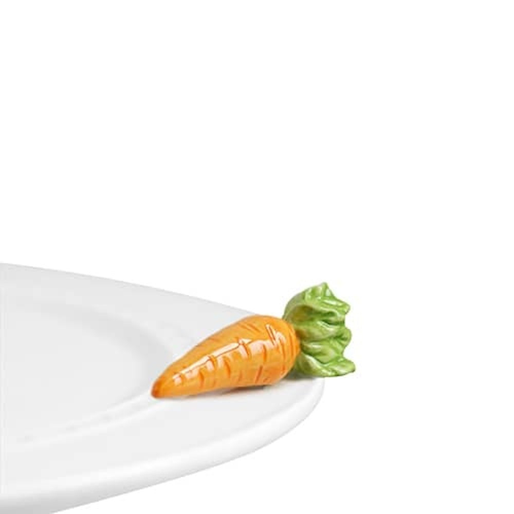 Ceramic carrot decorative attachment on the edge of a white serving platter, perfect for Easter or garden-themed decor.