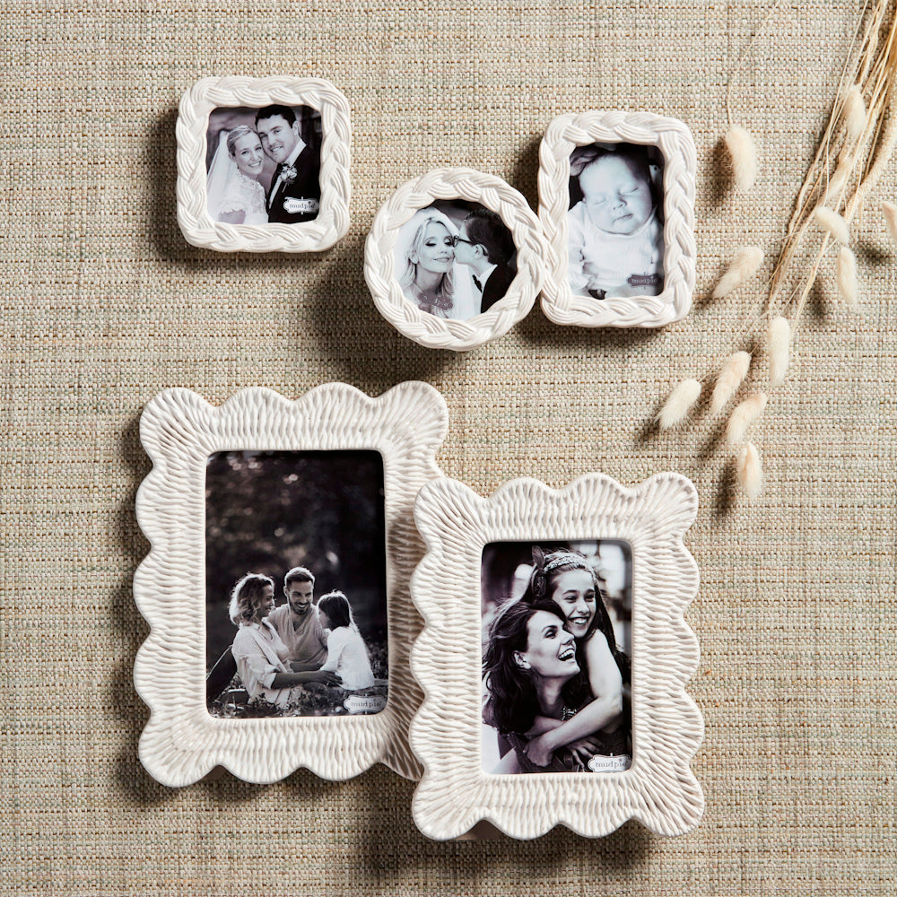 White textured stoneware picture frames with woven wicker patterns in various shapes on a neutral burlap background.