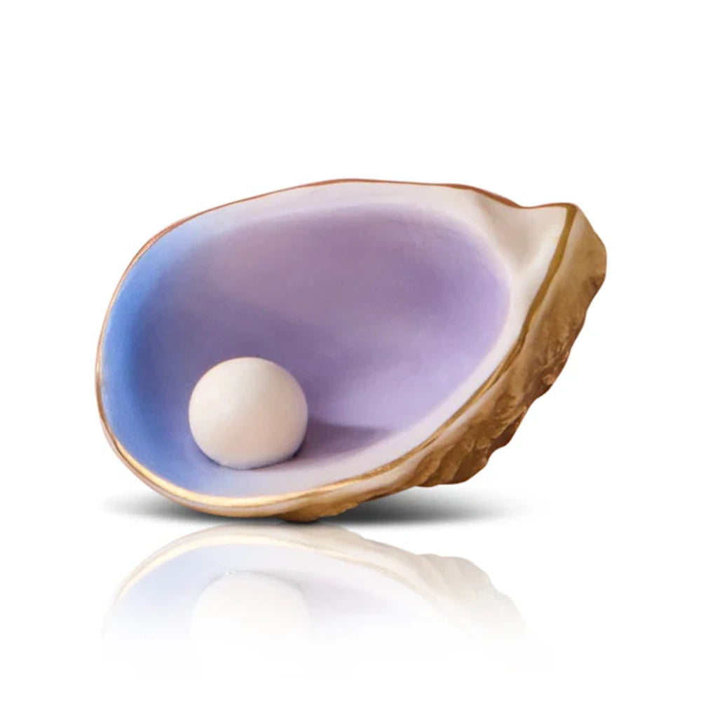 A decorative golden oyster shell with a purple interior containing a single white pearl.