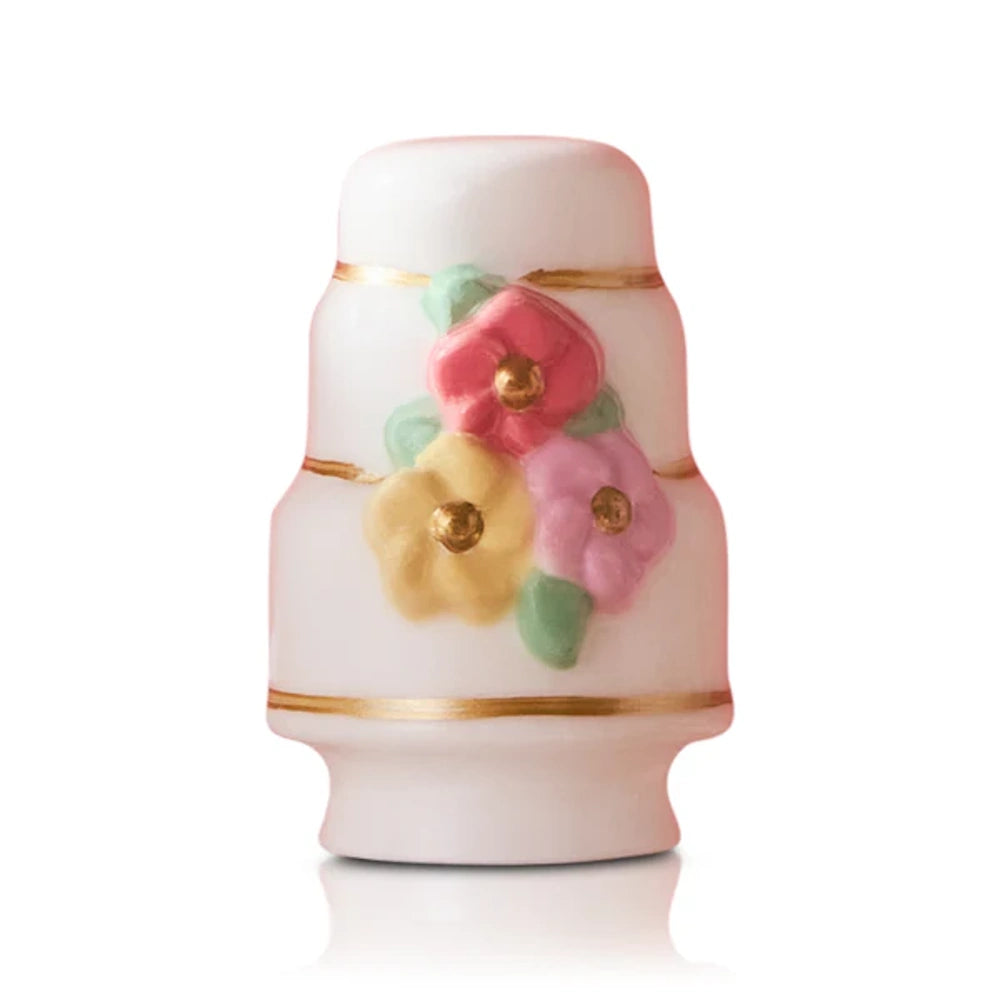 A vintage porcelain floral thimble.