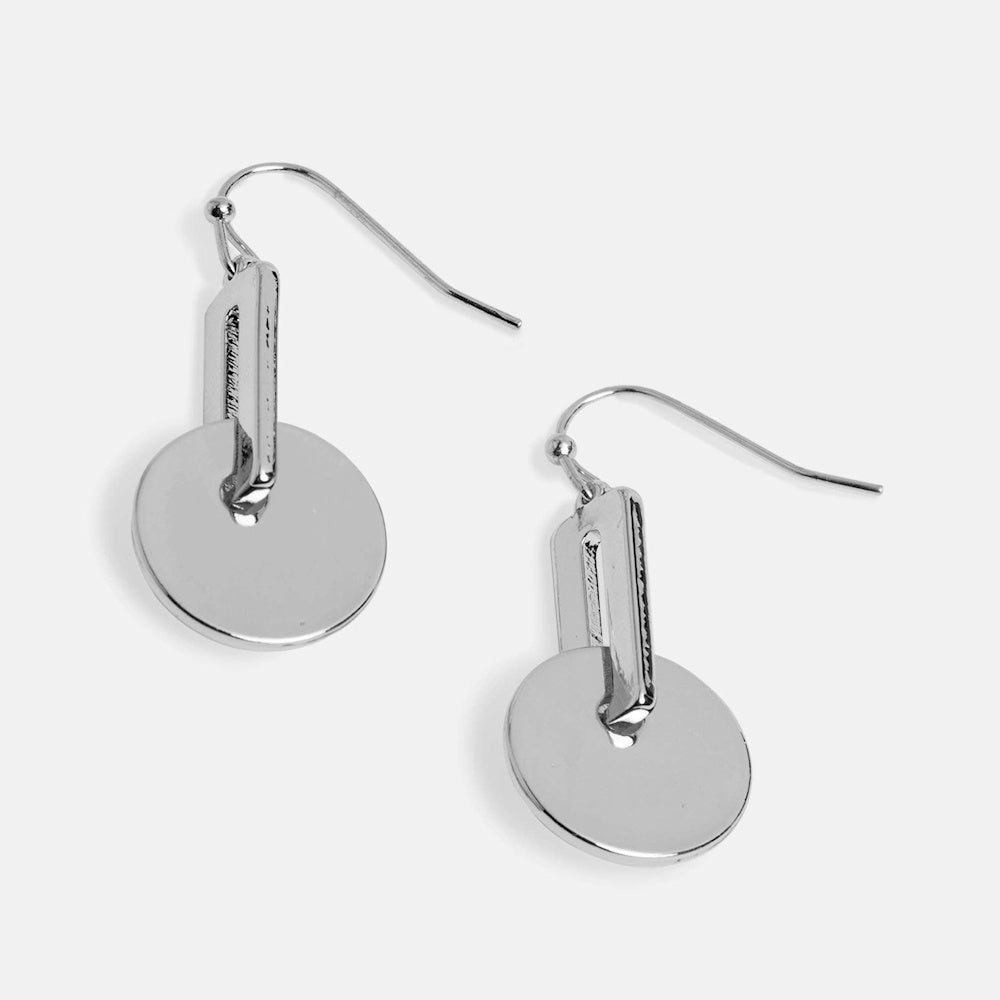 Modern silver disc dangle earrings featuring a geometric bar drop and fishhook back on a light gray background.