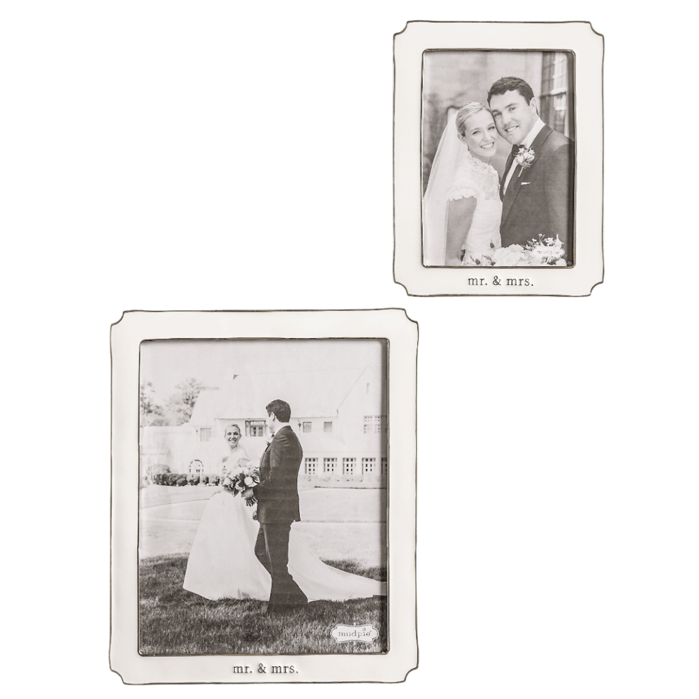 Two white enamel picture frames with scalloped edges, containing black and white wedding photos and "mr. & mrs." text.