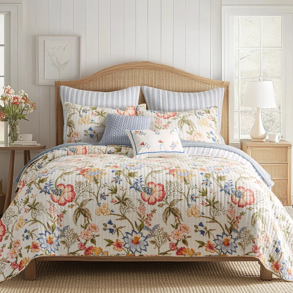 Bed styled with a colorful floral quilt set, matching pillow shams, and a woven wicker headboard.