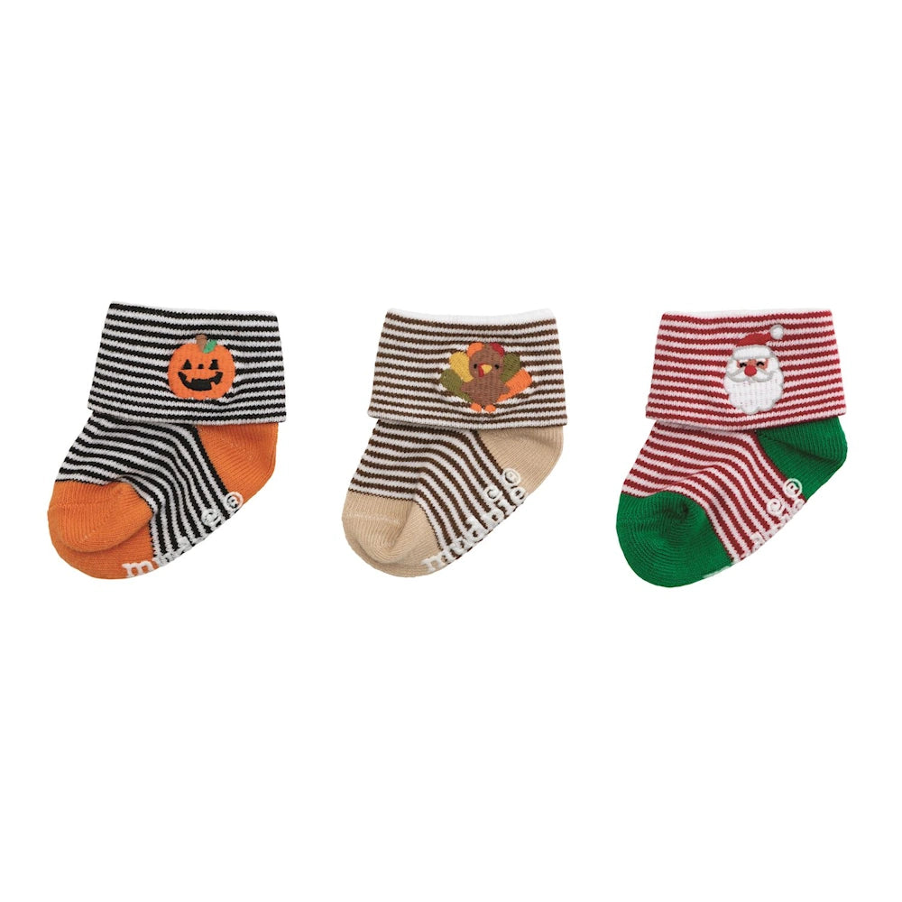Three pairs of Mud Pie striped baby socks with cuffs featuring pumpkin, turkey, and Santa Claus embroidery.