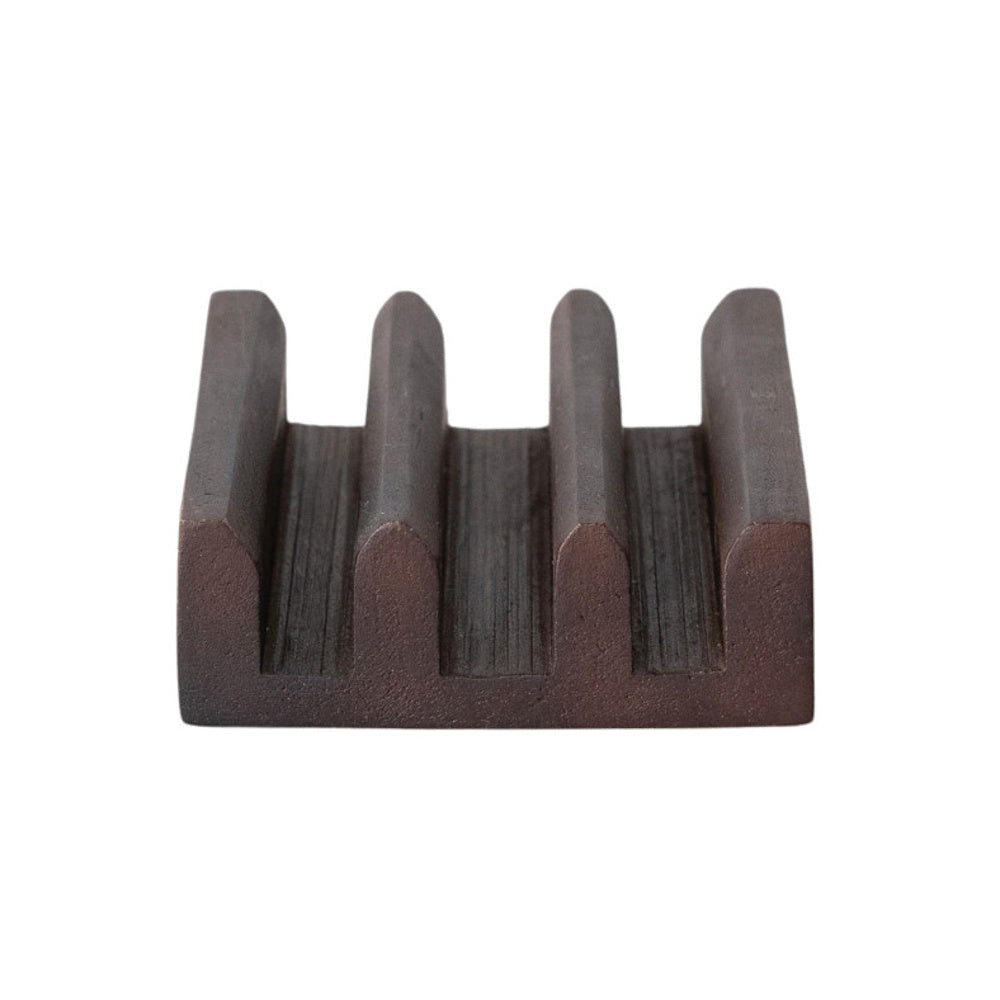 A dark brown, textured wooden stand featuring three open storage sections separated by four vertical ridges.