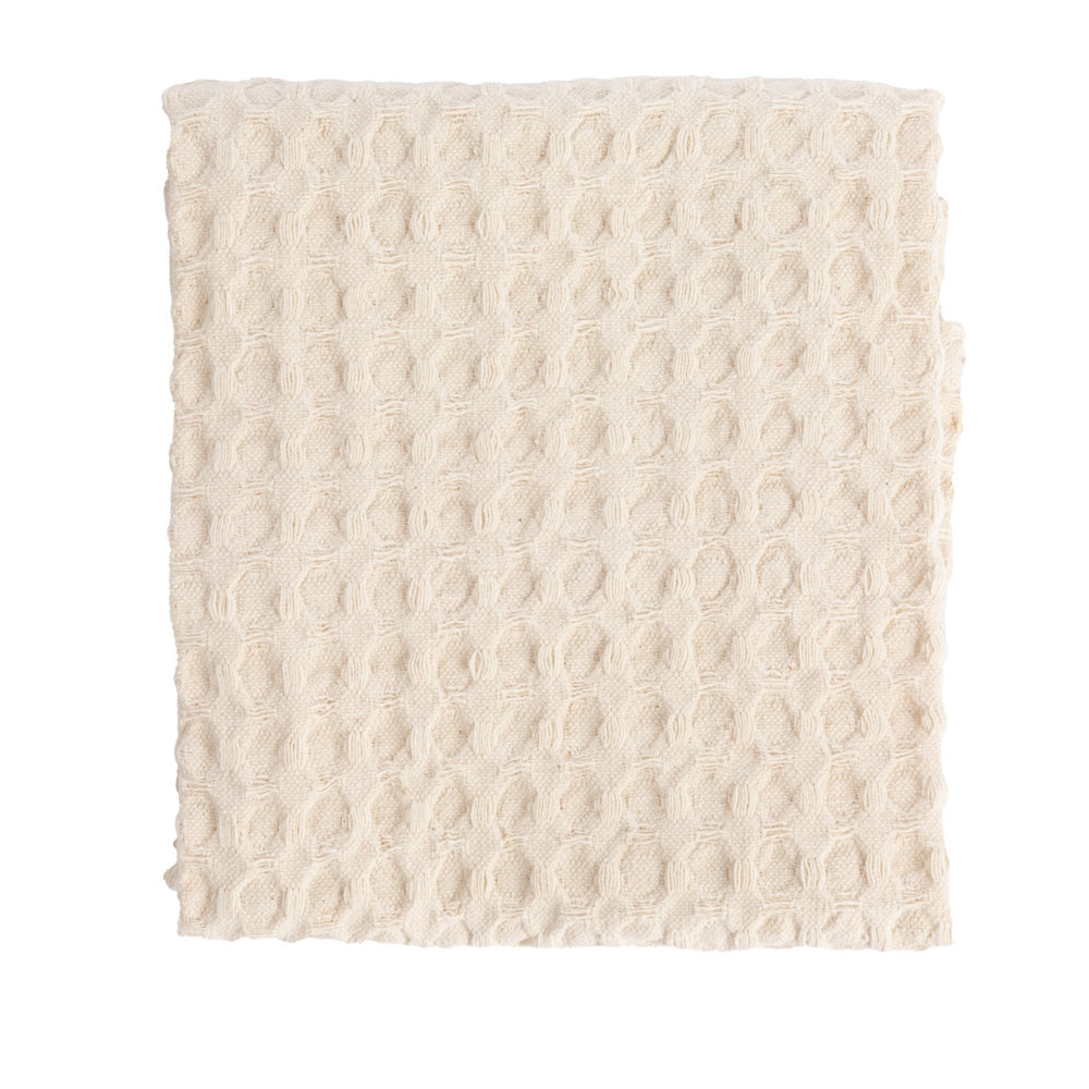 Folded natural stonewashed cotton waffle weave tea towel.
