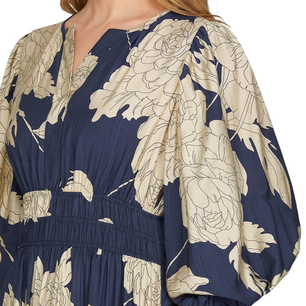 Close-up of navy blue and beige floral print woven dress featuring a notched neckline and smocked waist.