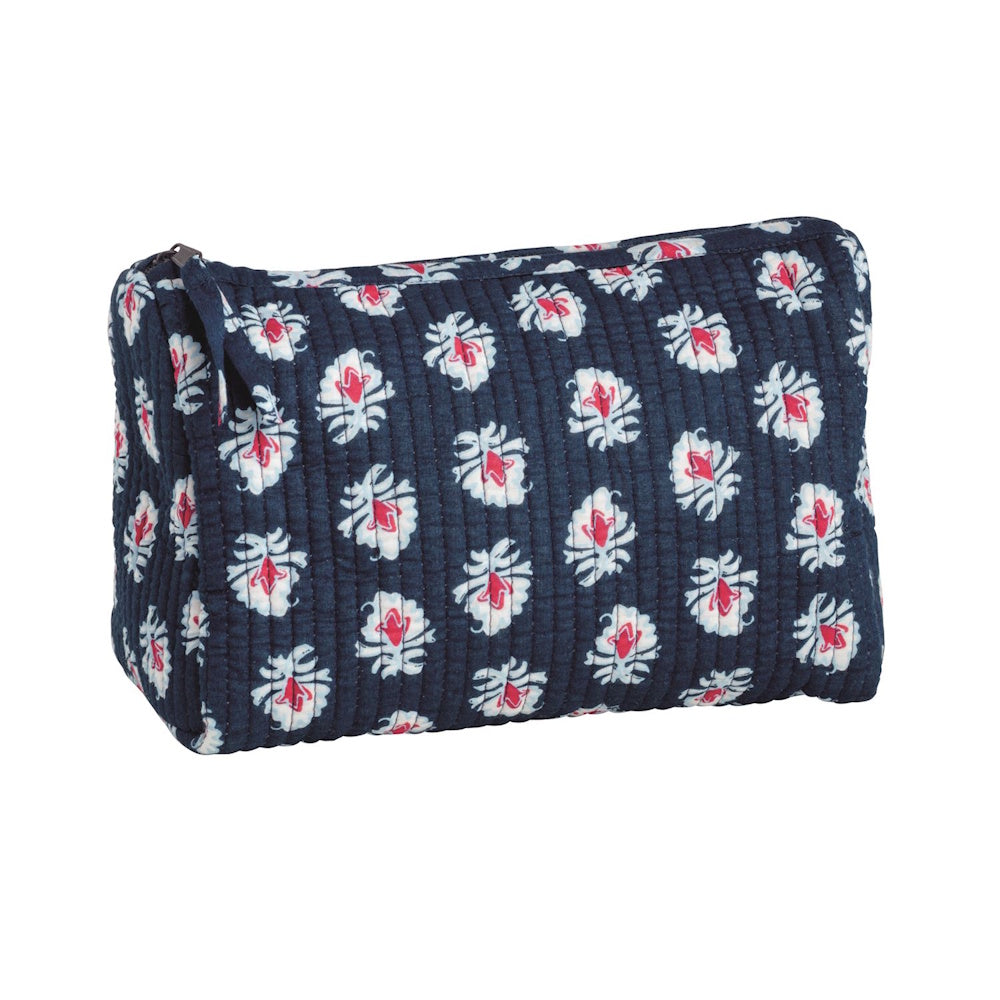 Quilted navy blue block-print cosmetic bag with white and red floral patterns and a zipper closure.