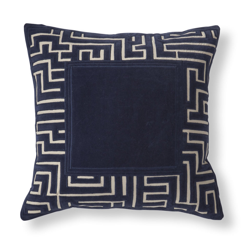 Square navy velvet throw pillow with a beige geometric maze border design.